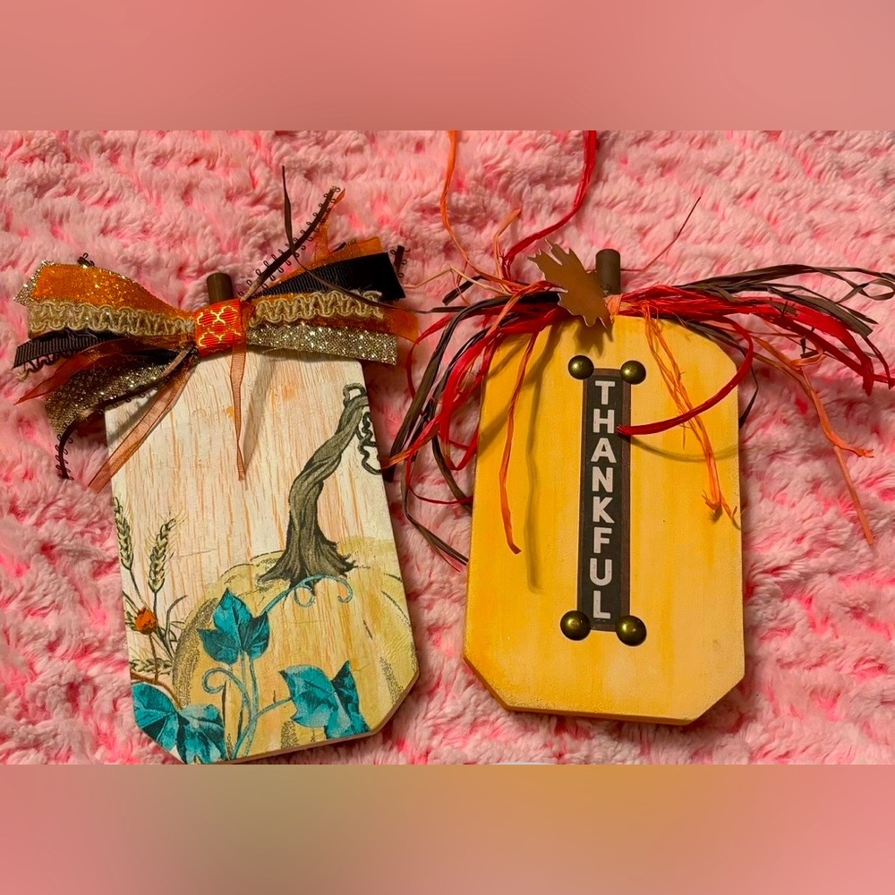 2 WOOD PUMKINS WITH DESIGNS IN THEM